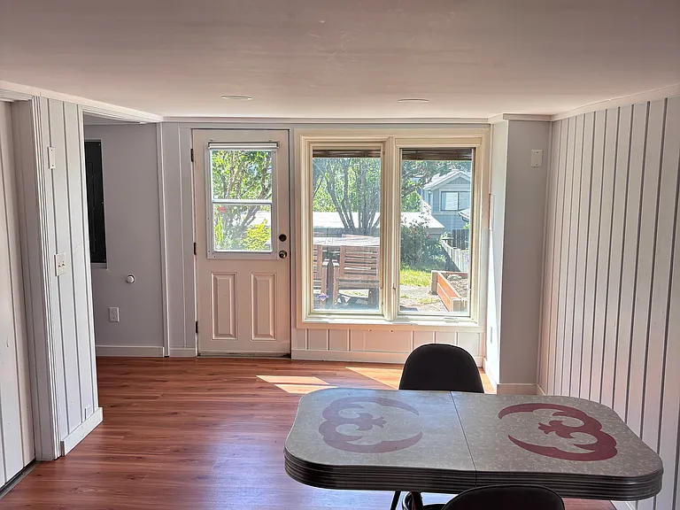 Looking from kitchen back to entryway door, open area past dinette for living area or office/workspace
