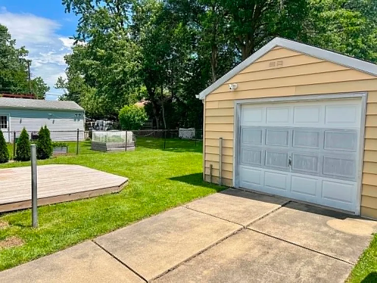 Single car garage, great for tucking away a small car or storing the lawn mower, snow blower, and other storage needs. New floating, wooden deck at the back of the house for your patio set.