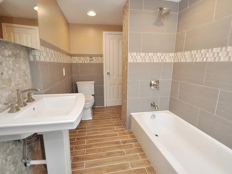 Marble, Granite, and porcelain Tile bathroom with heated floors and spa-quality fixtures and tile-work.