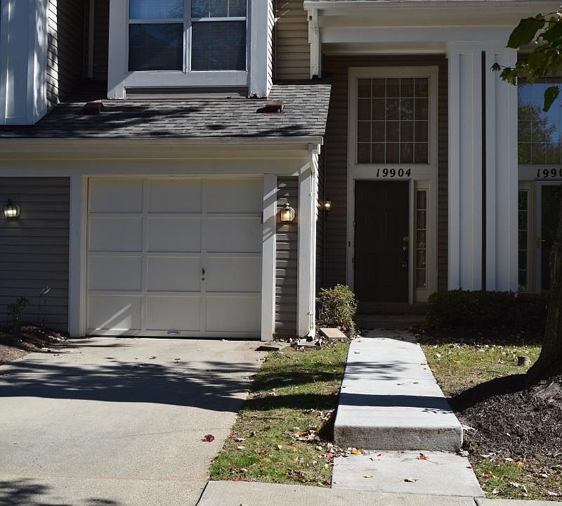 Front of townhome with garage and driveway