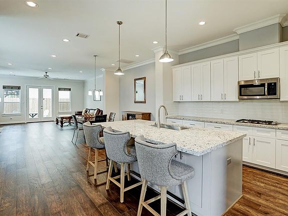 You will love the open concept flow of the first floor living. The kitchen has granite countertops. A large island with front and back cabinets for storage and a stainless steel farmer's sink.