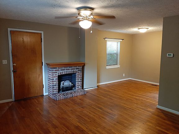 Living room with gas log fireplace. Dining area.
