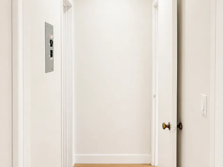 Freshly updated interior hallway with recessed lighting and new flooring throughout.