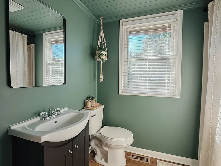 En-suite bath has a full-size bathtub and vanity