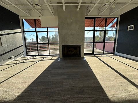 Living Room with lots of natural light facing exterior balcony.