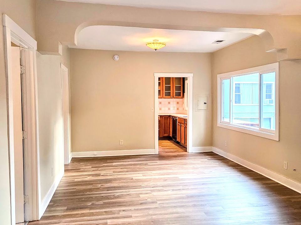 Main room. Kitchen door at rear. 3 bedroom doors open into the main room and bath hallway opens to the bathroom.