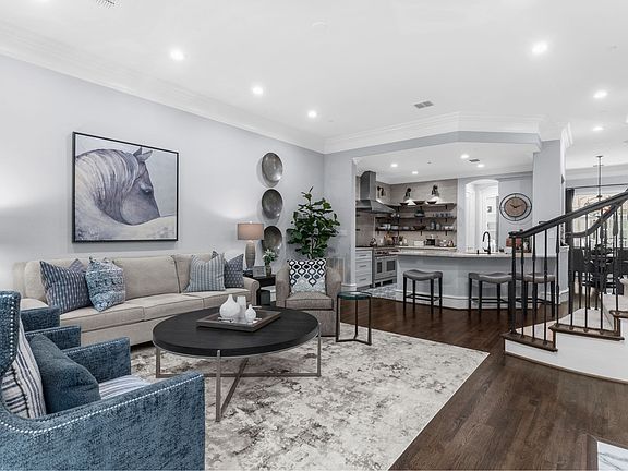 Elegant 2nd-floor living space featuring a cozy fireplace and seamless flow.