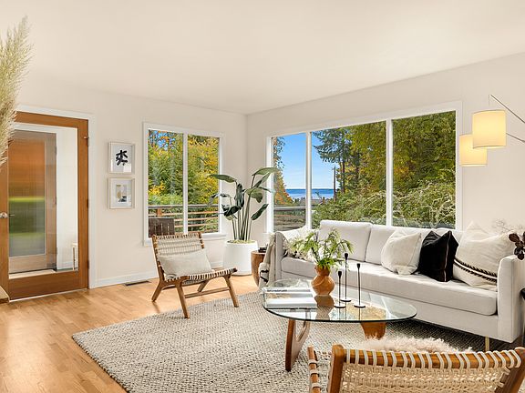 Large windows in living room allow plenty of light and outlo