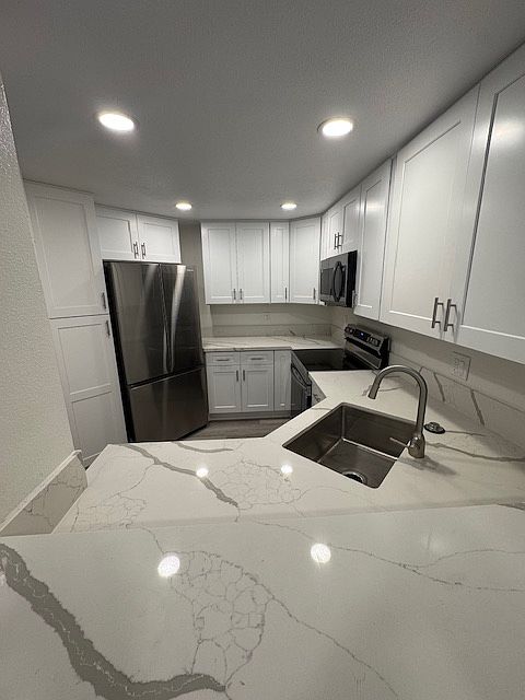 Fully remodeled kitchen with stainless appliances and recessed lighting