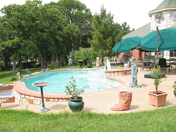 Large, in-ground, heated pool with waterfall features.