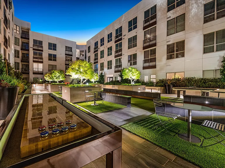 Courtyard game lounge with shuffleboard table and seating