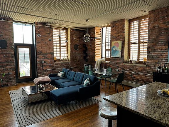 Open floor plan in corner unit with huge windows