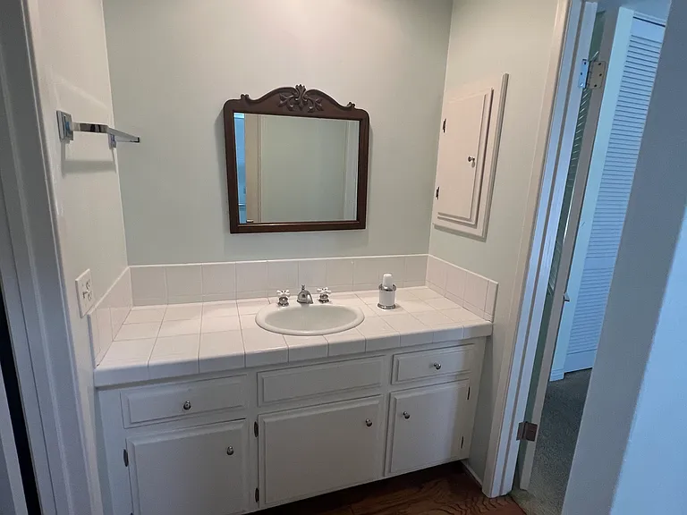 Jack and Jill Bathroom between two bedrooms with water closet & step in shower.