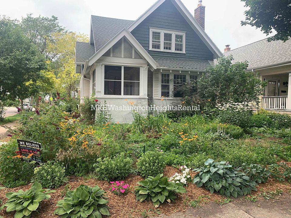Exterior. Many flowers, rose bushes, and plants.
