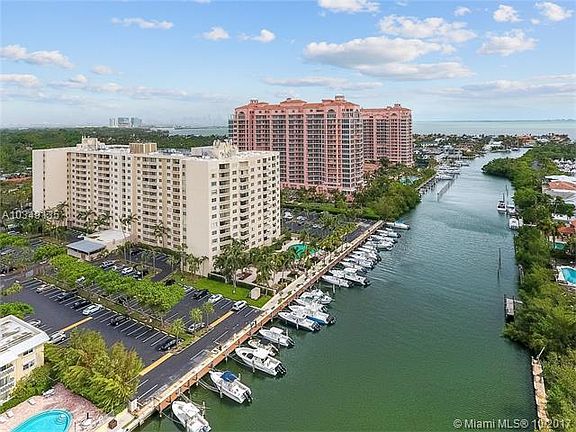 Overview of building with pool, waterway and gated parking shown