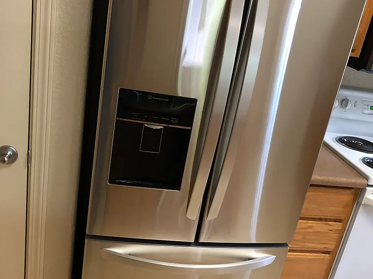 Newer LG fridge with filtered water and Ice maker.