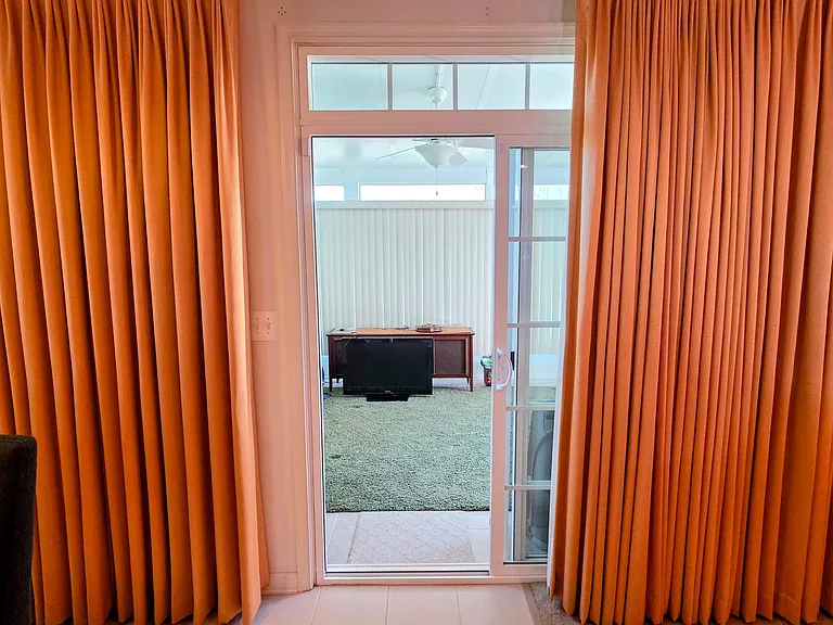 Light-filled sunroom with sliding glass door access_an ideal space for a home office, yoga studio, or bonus lounge.