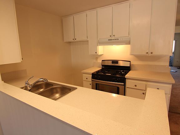 Remodeled kitchen with quartz countertops, newer sink, newer stainless steel appliances.
