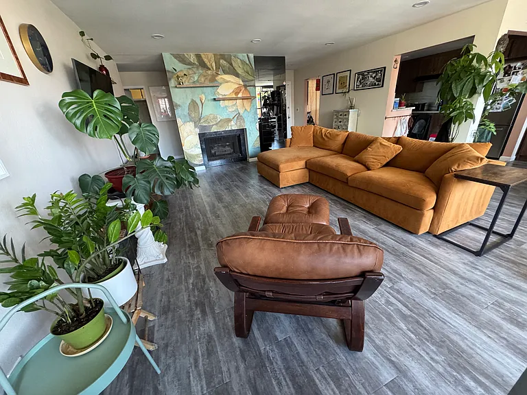 Living Room facing toward natural gas decorative fireplace and wall bar.