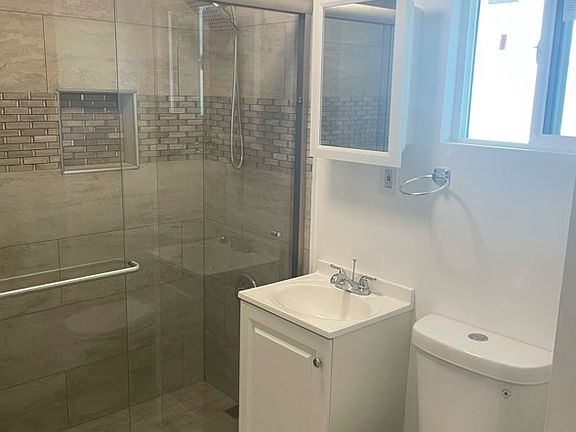 Bathroom: New fixtures, tile, sink, and showerhead