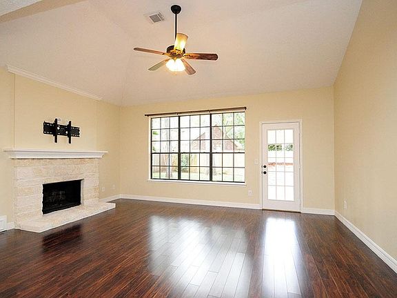Beautiful laminate wood floors warm up this family room, along with the handsome fireplace.