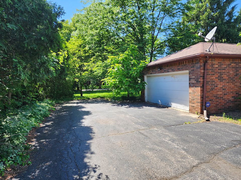 Personal garage with extra paved parking spots beyond