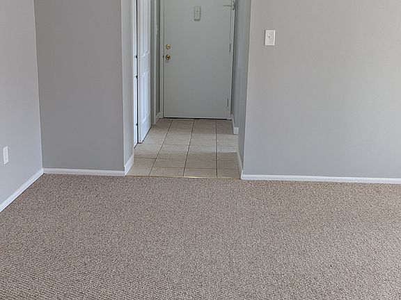 View of the Unit entry hallway and coat closets from the living room.