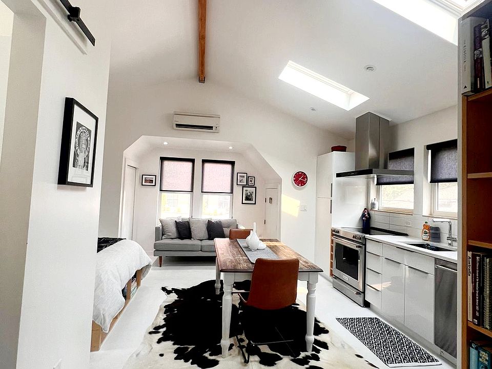 Looking into the apartment from the entry. Comfy 2 seater couch.