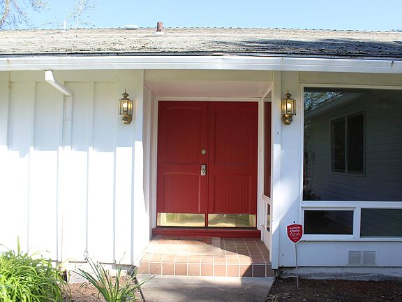 The house exterior has recently been painted and the front entry updated with glossy black door and new light fixtures