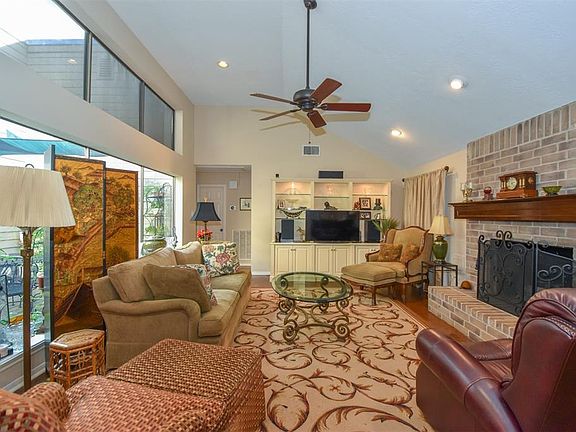 High ceilings, wall of windows, and recessed lighting that enhances the living area of your new home.