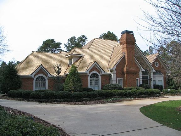 4 side brick home with circular drive and side entry garage