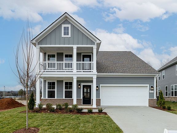 Exterior of home with covered front porch and balcony