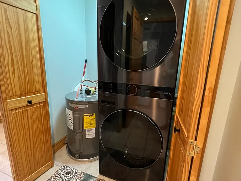 Brand new large capacity LG stacked washer/dryer. 38 gallon low boy hot water tank for bath and laundry area.