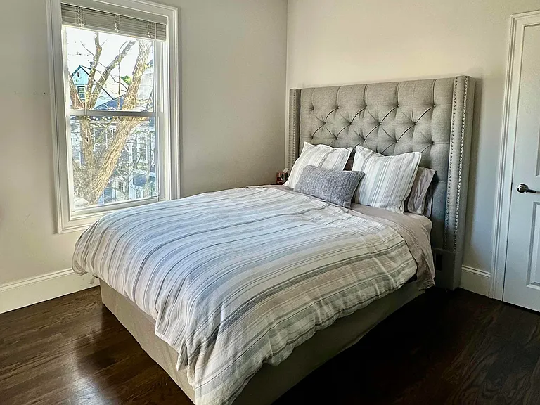 Comfortable second bedroom with natural light and a walk-in closet.
