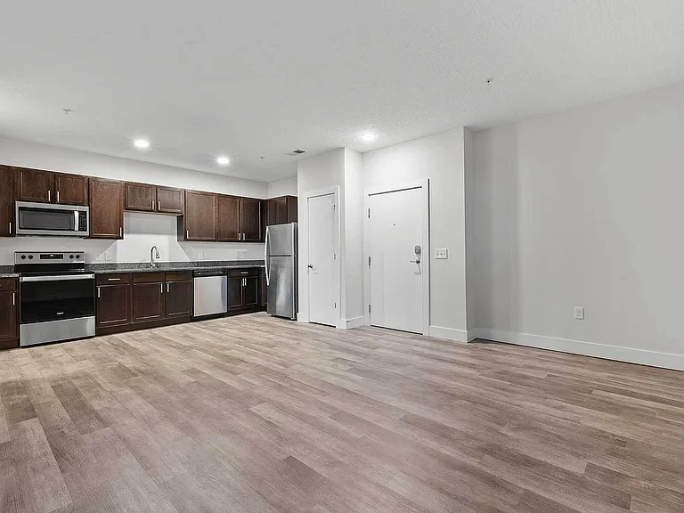 This two-bedroom floor plan features an open layout with durable wood-style flooring, stainless-steel appliances, and modern finishes _ blending comfort and convenience in the heart of Clintonville. This two-bedroom floor plan features an open layout with