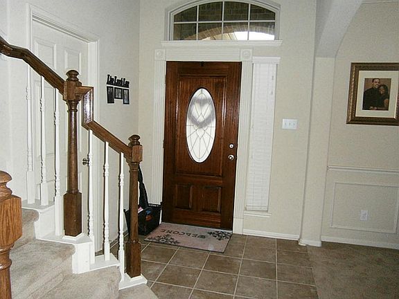 Entry hall with a leaded glass front door and tile floor.