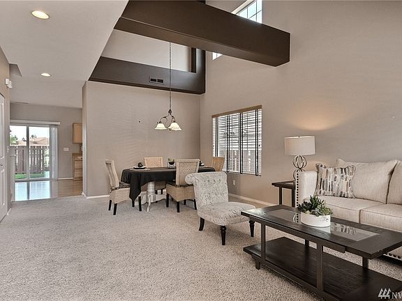 Welcome to this elegant and spacious entry way boasting vaulted ceilings, dining room, & formal living room