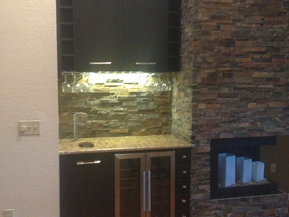 Wet bar with fridge and electric fireplace