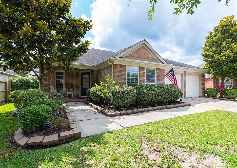 Front of house with cozy covered porch.Relax here with your morning coffee.