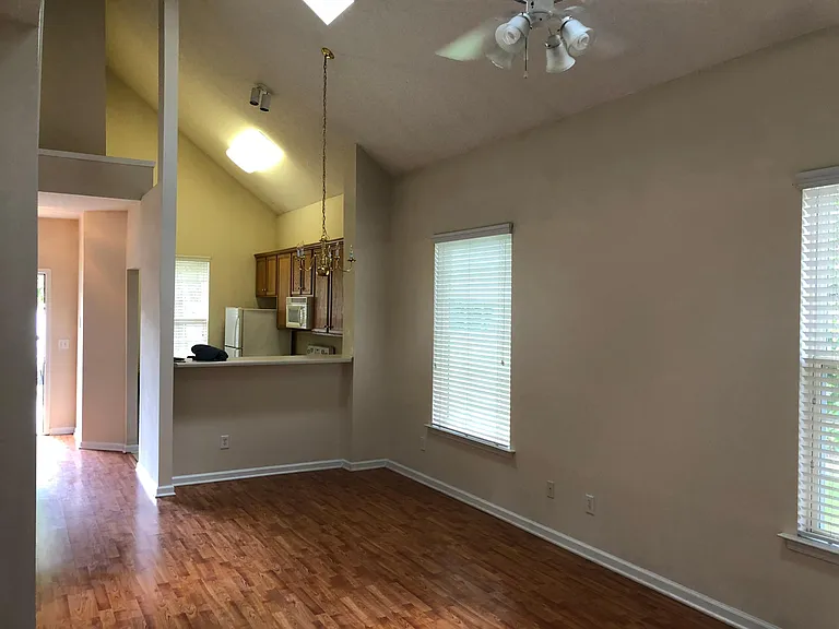 living room showing kitchen and front door