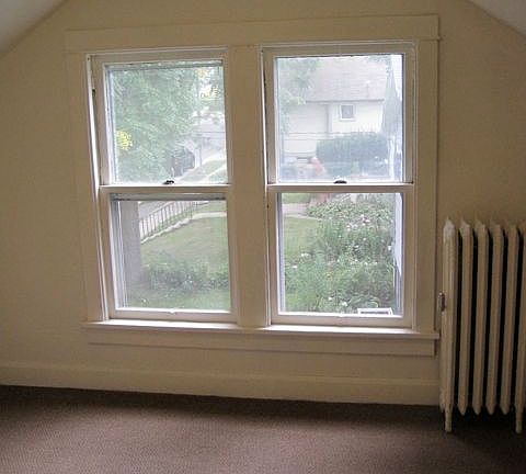 Bedroom features windows with garden views