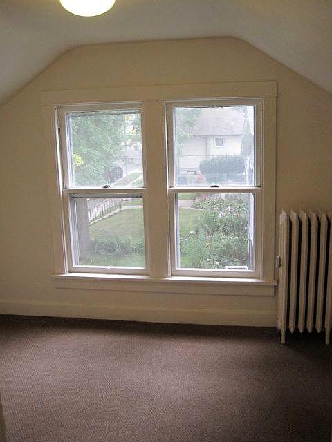 Bedroom features windows with garden views