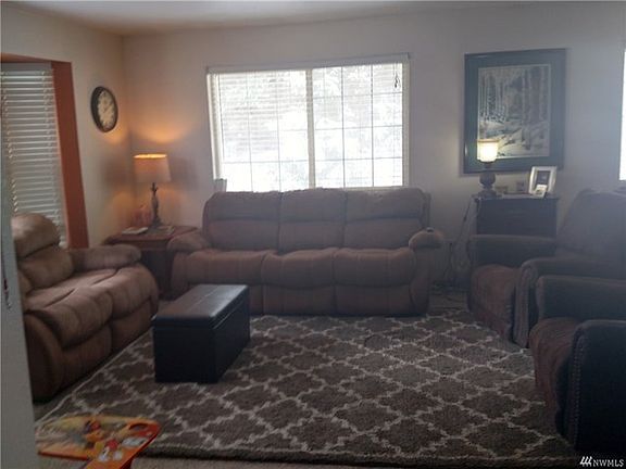 Living room area, two large recliners and two full length couches show how spacious this room is.