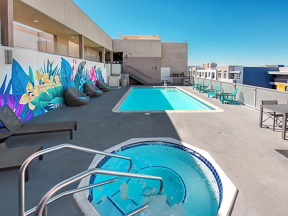 Rooftop with spa, swimming pool, BBQs, and lounge chairs.