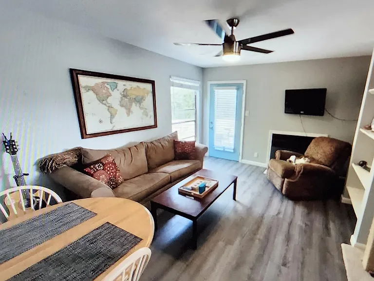 living room with working fireplace door in pic leads out to the backyard