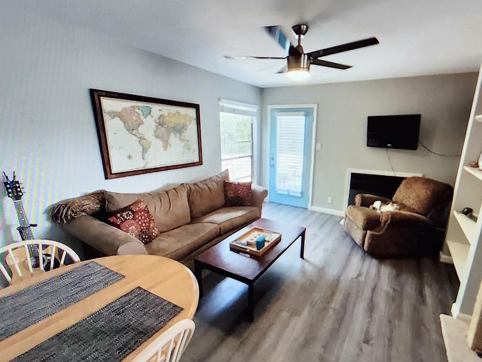 living room with working fireplace door in pic leads out to the backyard