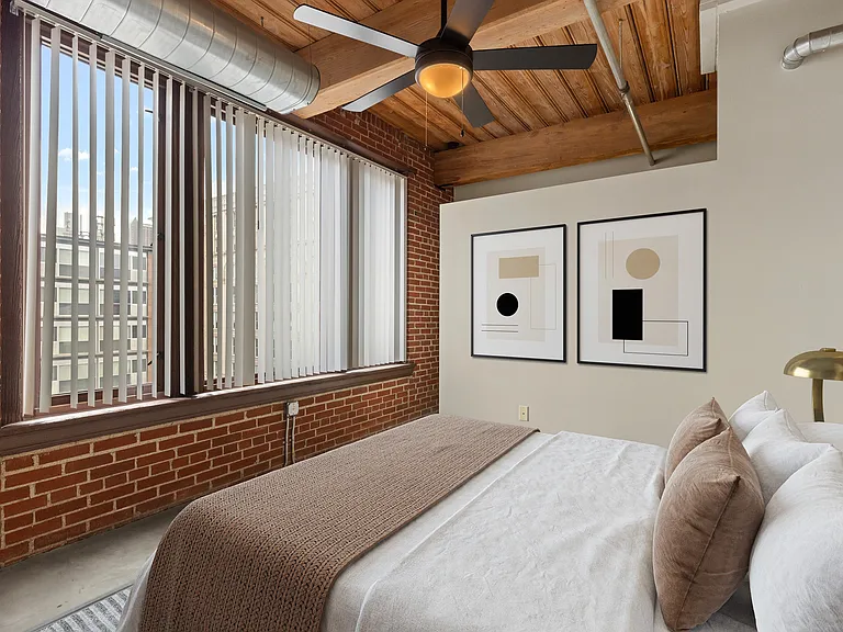 Chic urban bedroom with exposed brick walls