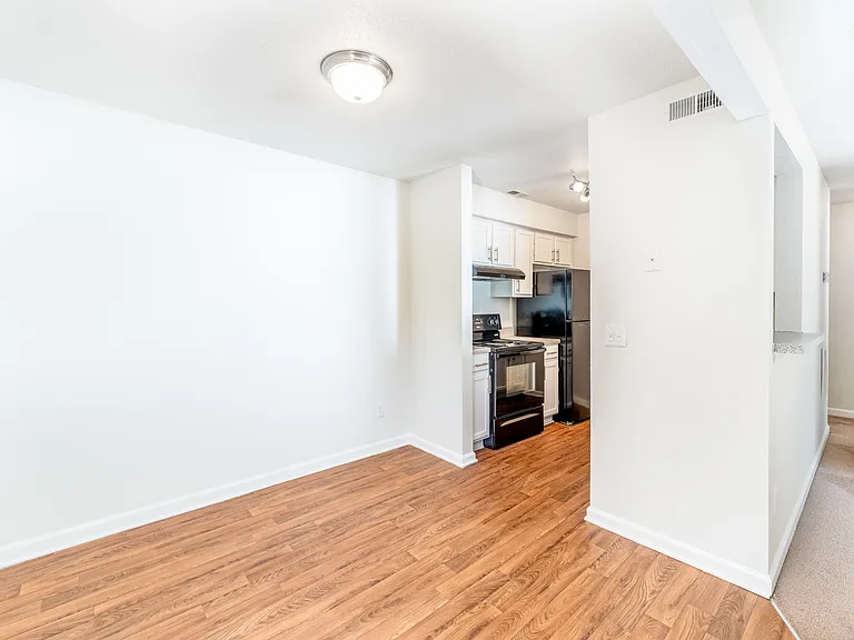 Open-Concept Dining Area with Chestnut Wood-Style Flooring - Gold Interior