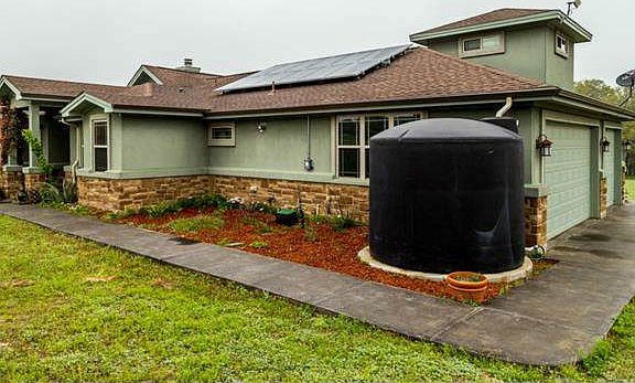 Solar panels and dual water retention for the garden/vinyard are two of the sustainable features this home has to offer. New cement flat work surrounding the house.