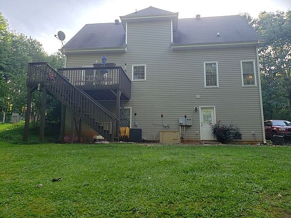 Back of house with deck